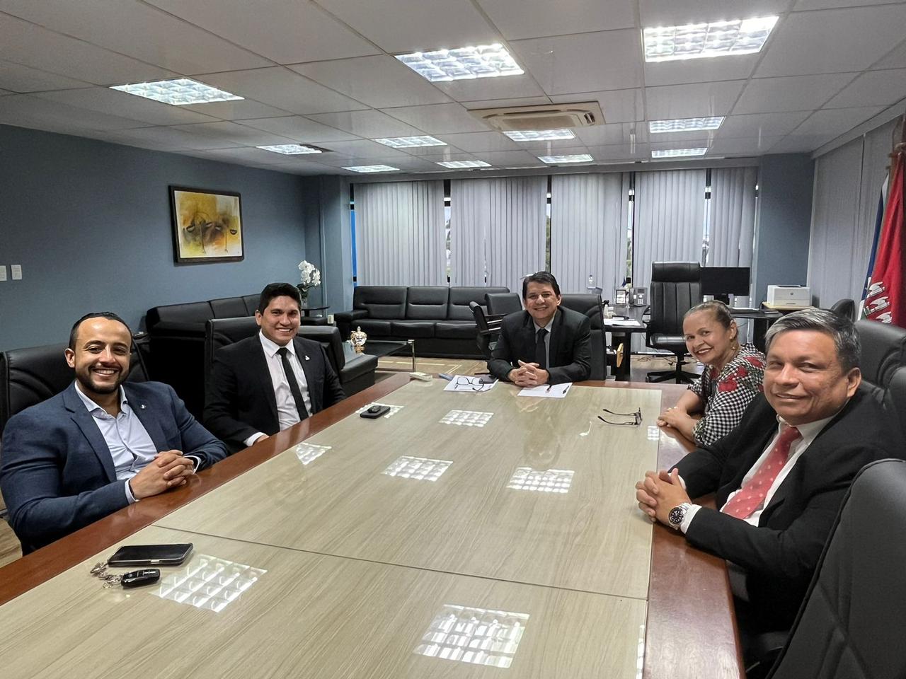 Foto colorida mostra seis pessoas sentadas a mesa posando para a foto. Na foto aparecem, o presidente do TJRR, desembargador Jésus Nascimento, o presidente da AMARR, juiz Marcelo Oliveira, o juiz Corregedor do Tribunal de Justiça de Roraima, Phillip Barbieux, a juíza titular da Vara da Justiça Itinerante, Graciete Sotto Mayor e o magistrado Paulo Cesar Dias Menezes.