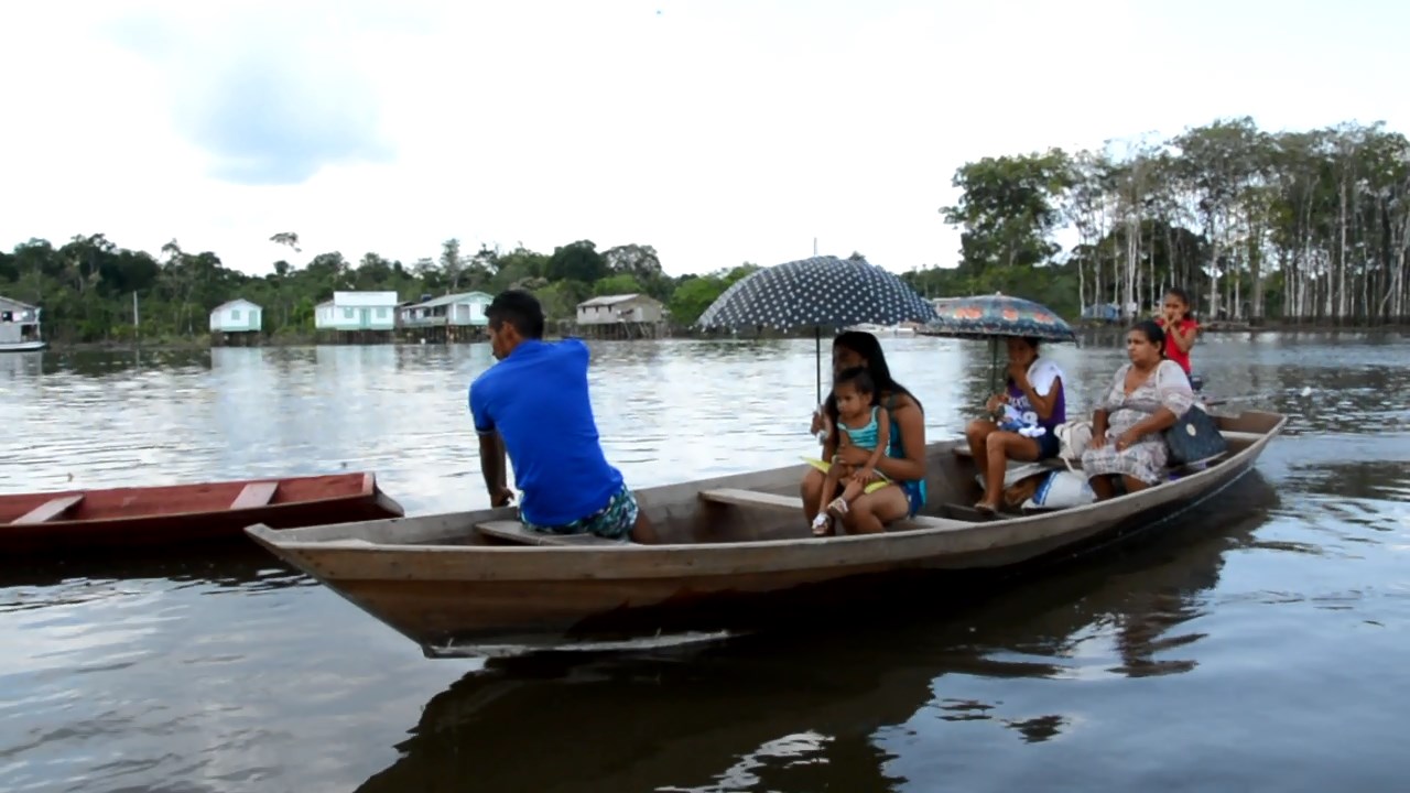 Ribeirinhos chegando de canoa para atendimentos na embarcação da Jusitiça Itinerante 