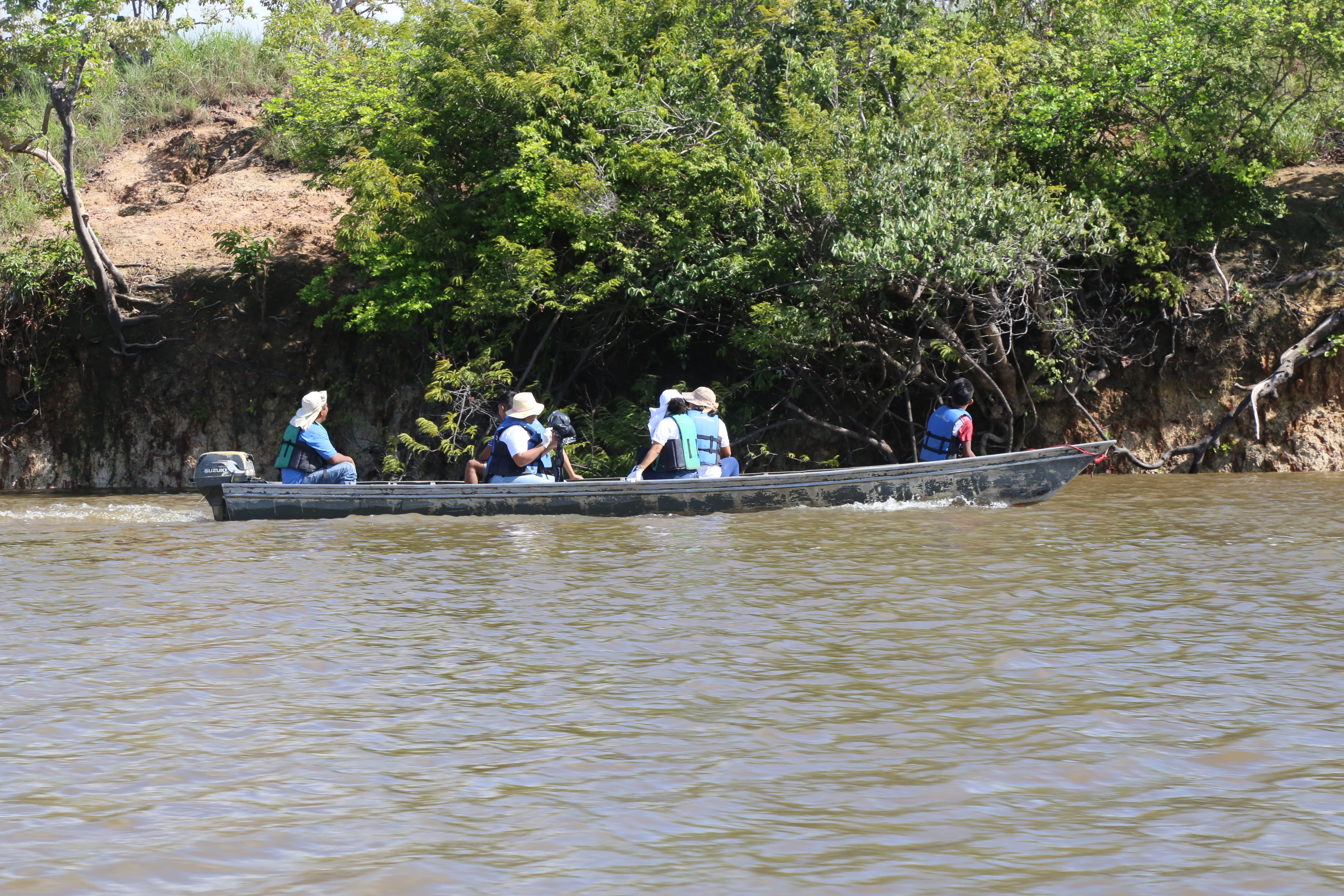 Equipes de voluntários percorrendo o rio de barco em busca do lixo que é despejado no rio Branco.  